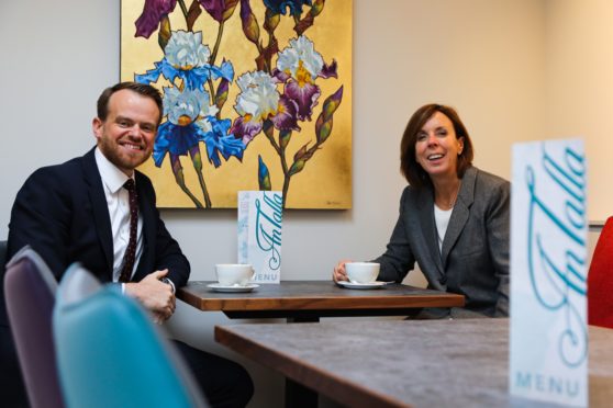 Barrie Aird of the Bank of Scotland and Freda Newton enjoy coffee in An Talla