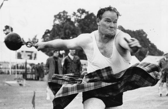 Braemar Gathering 1970-09-02 Bill Anderson (C)AJL
Used P&J 03.09.1970
Bill Anderson throws the 56lb. weight by ring to win the event. The picture clearly illustrates the determination and power of Bill's effort.