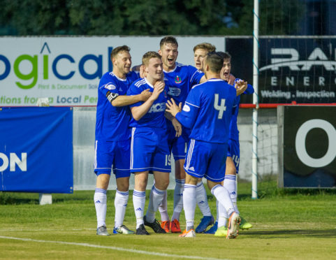 Cove Rangers players congratulate John Robertson after his late winner.