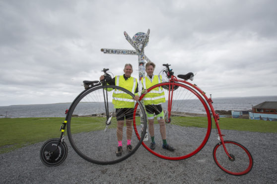 Neil Laughton (L) and David Fox-Pitt at John O'Groats after completing their marathon from Lands End, on Penny Farthing bicycles.