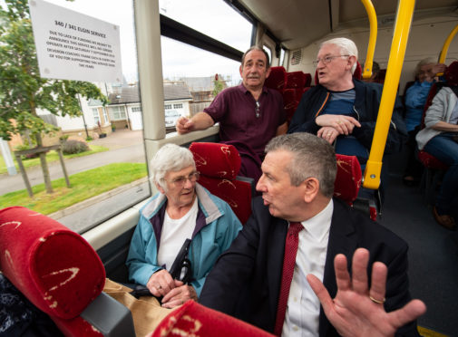 Highlands and Islands MSP David Stewart talks to passengers on the bus.