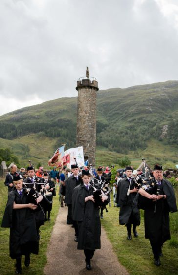 Lochaber pipe band lead the march from monument to games field