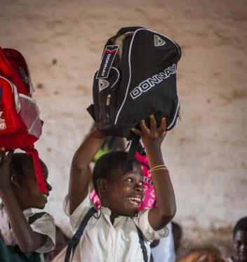 Children in Malawi receiving backpacks