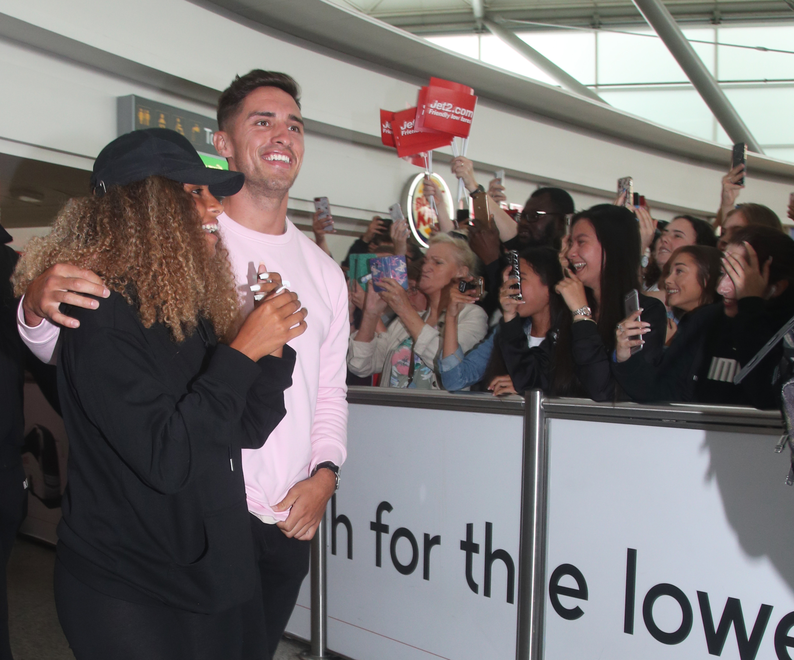 Love Island winners Amber Gill and Greg O'Shea greet fans as they arrive at Stansted Airport in Essex following the final of the reality TV show.