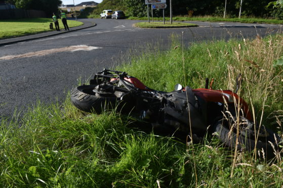The motorbike at the side of the road following the crash