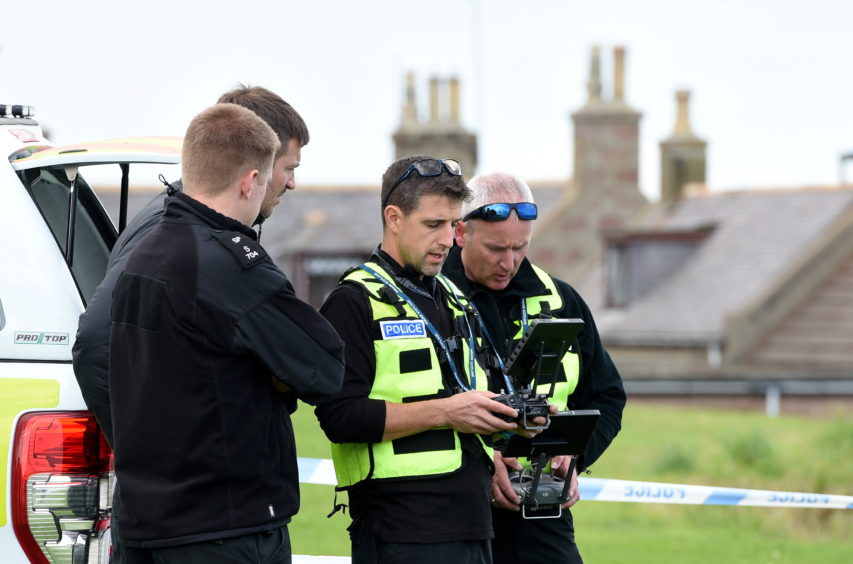 Police officers using a drone at Gadle Braes in Peterhead.
