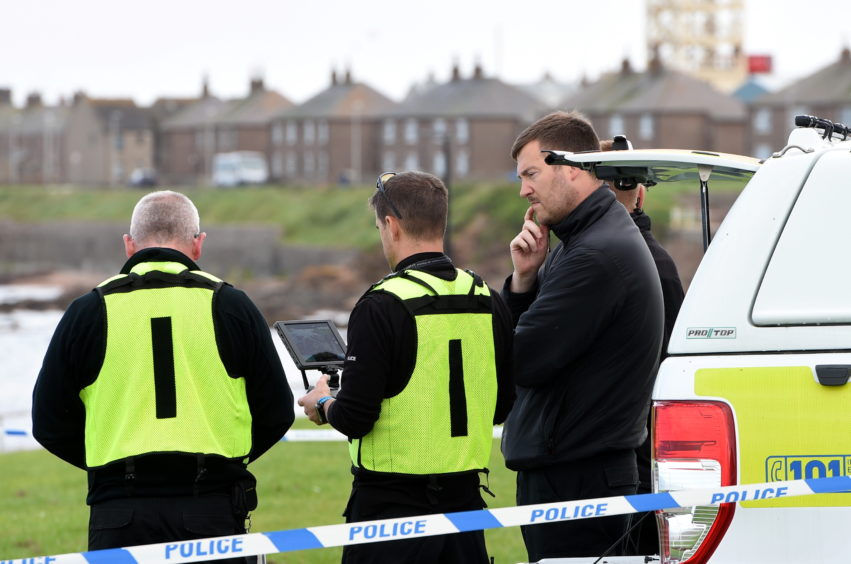 Police officers using a drone at Gadle Braes in Peterhead.