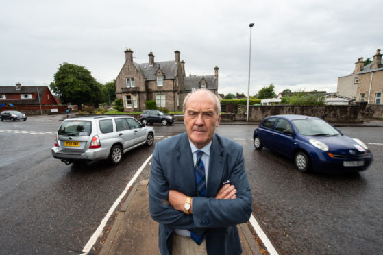 Councillor George Alexander at the junction of Orchard Road and St Catrherine's road in Forres last year