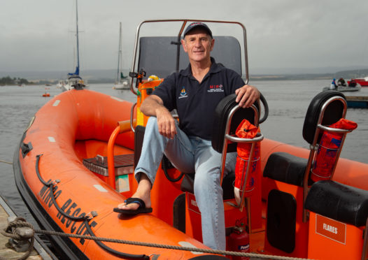 Retired deputy coxswain Donald Watson upon the Lifeboat 'Miro' at Findhorn Harbour