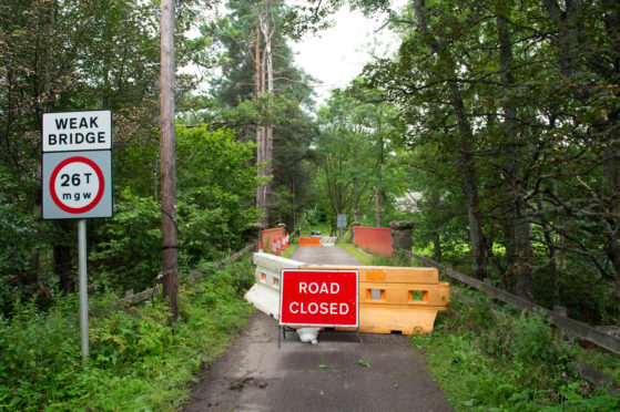 The closure of Delfur bridge at Boat-O-Brig in Moray with sandbags and bridge damage.