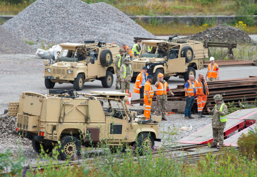 Foxhounds and Landrovers are loaded onto a freight train at Elgin train station, Moray, destined for Salisbury Plain in Wiltshire.