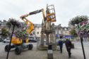 Pictures by JASON HEDGES    
[LOCATOR] Survery of the Market Cross in Forres is being carried out today. 
Pictures by JASON HEDGES