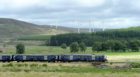 ScotRail train passes the Moy Windfarm as it heads to Perth