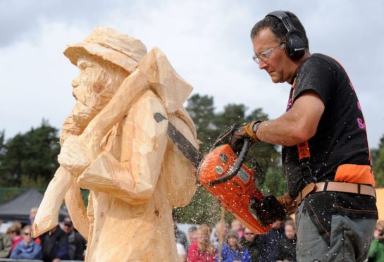 Participants use chainsaws to carve the designs into large blocks of wood. Image: Sandy McCook/DC Thomson.