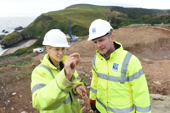 Cabinet Secretary for Transport, Infrastructure and Connectivity Michael Matheson and archaeologist Mary Peteranna thoroughly analyse one of the artefacts discovered. Picture by Sandy McCook