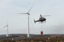 A helicopter assists at the scene of a wildfire at Paul's Hill Wind Farm near Knockando, Speyside. 
Picture by Jason Hedges