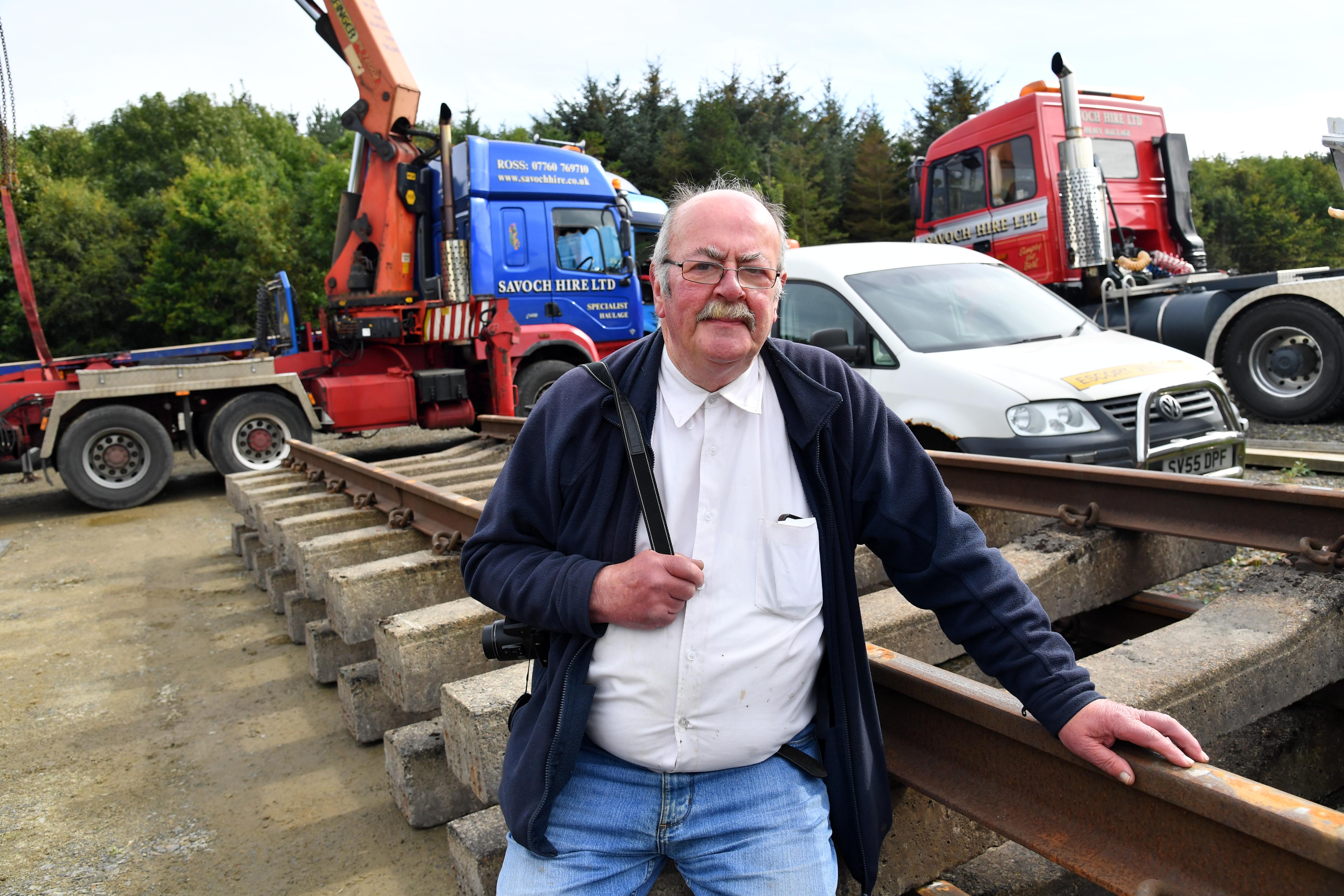 Alan Sangster, a trustee of the Maud Railway Museum, welcomes the arrival of two lengths of railway track.