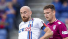 Inverness' James Vincent (L) in action with Arbroath's James Murphy.