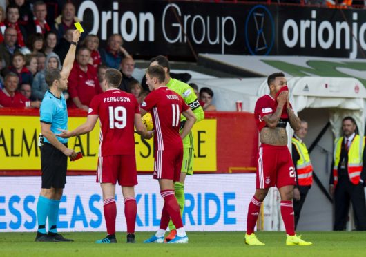 Aberdeen's Funso Ojo leaves the pitch after being red carded whilst team mate Joe Lewis is yellow carded for dissent