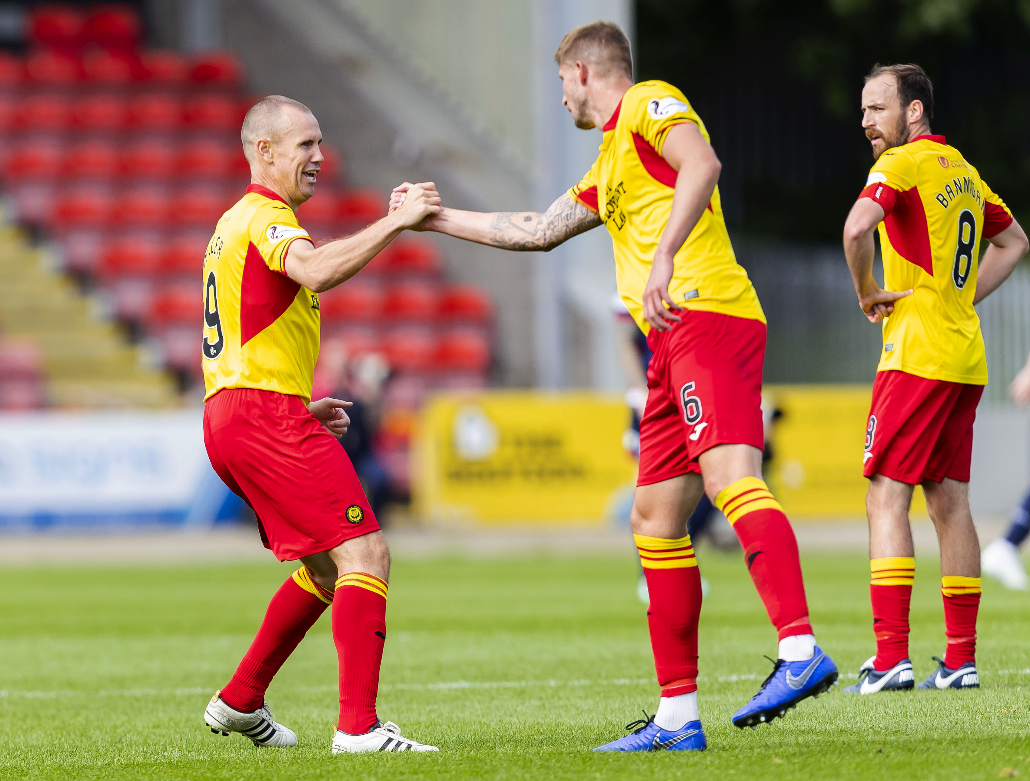 Partick's Kenny Millar (L) celebrates his equalizer with teammate Sean McGinty
