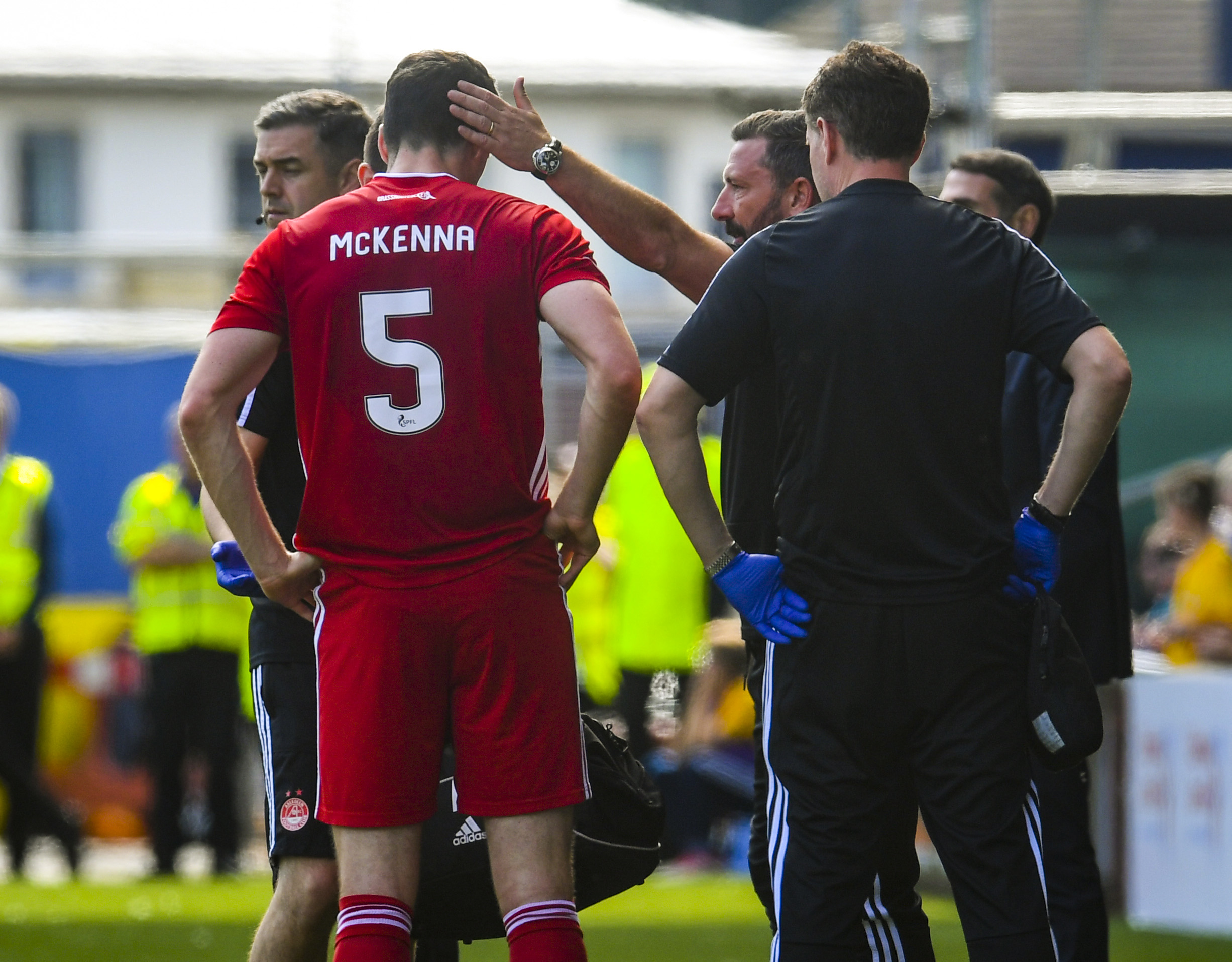 Aberdeen's Scott McKenna is forced off with a first half injury.