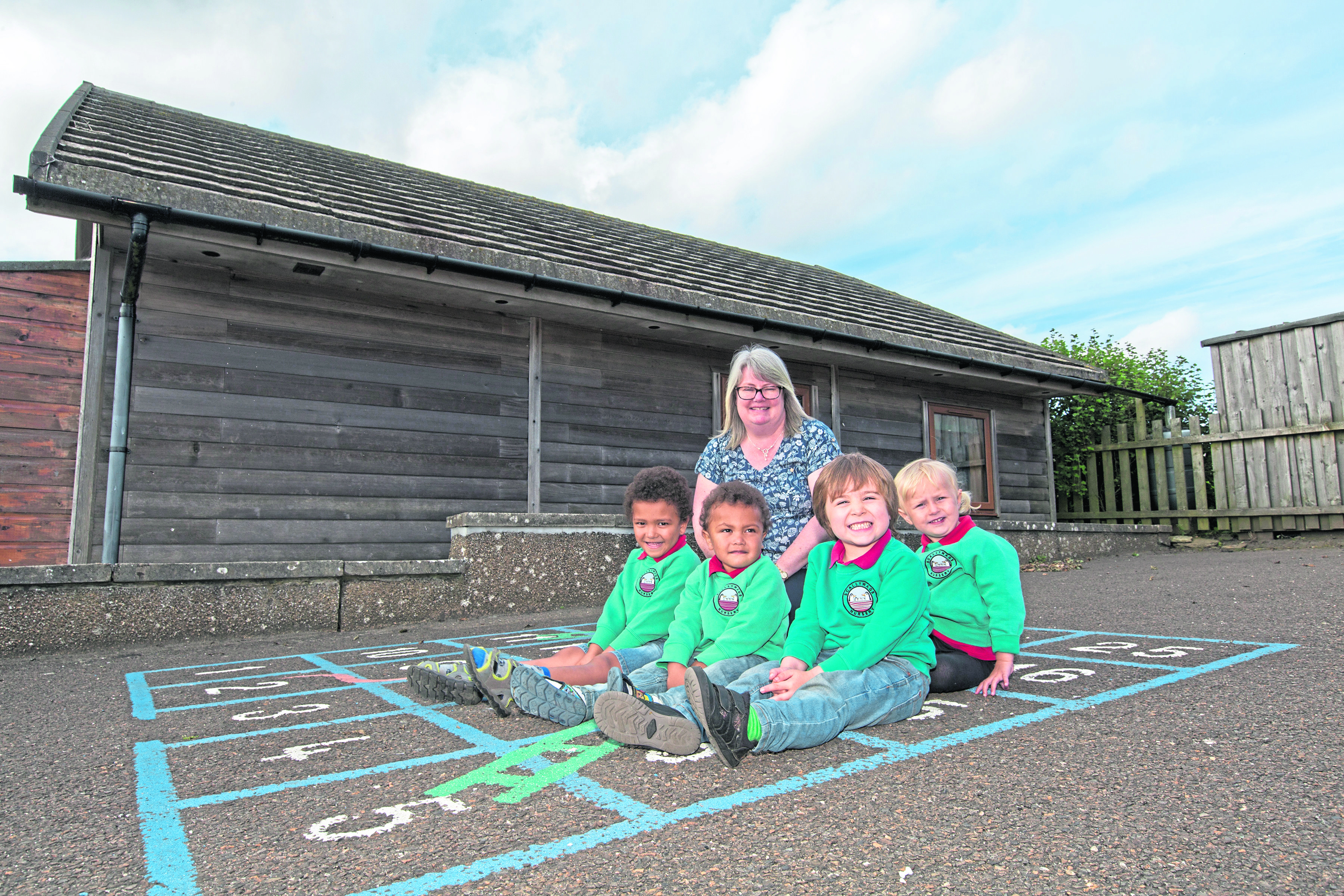Scallywags Nursery manager Karen Williamson, with four of her five pupils, from left, brothers, William and James Page, William Macdonald and Ellie Fogarty-MacDonald.  The nursery based at Crossroads School, Barrock, had been threatened with closure along with one at Bower Primary, but both have now been reprieved. Photo: Robert MacDonald/Northern Studios