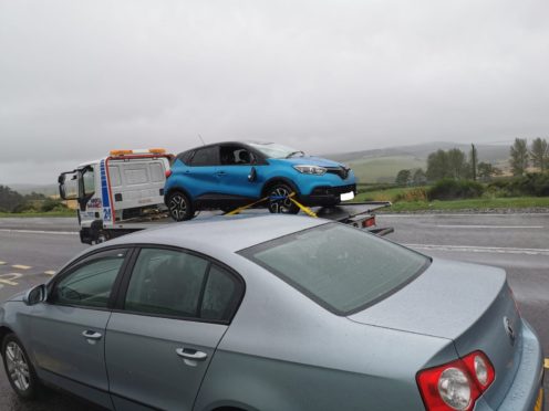 The car being removed by a recovery vehicle.