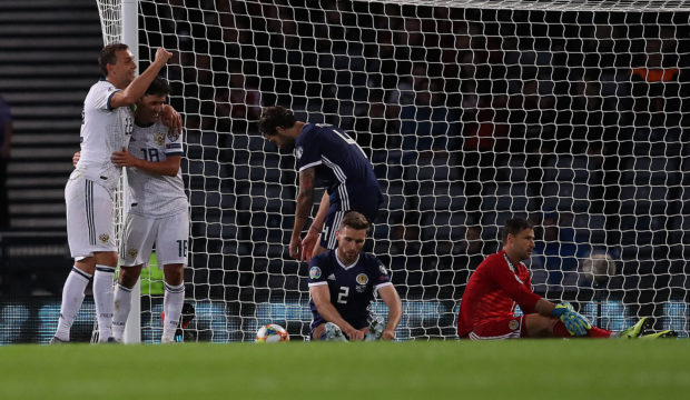 Stephen O'Donnell looks on as Yuri Zhirkov celebrates Russia's second goal.