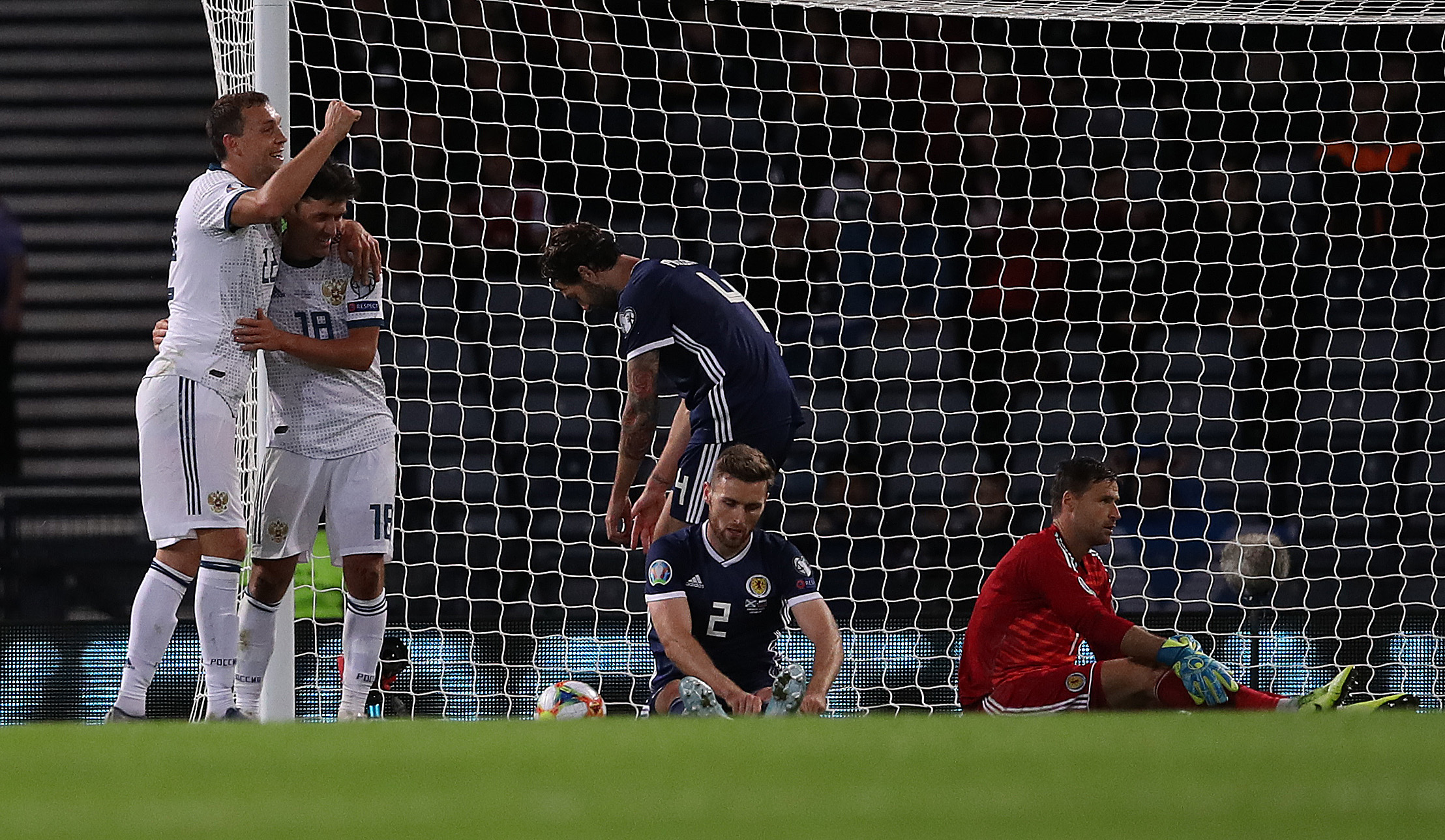 Stephen O'Donnell looks on as Yuri Zhirkov celebrates Russia's second goal.