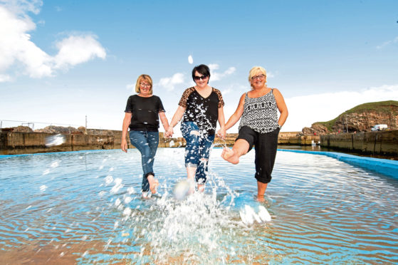Lillian Urquhart, Kirsty Farquhar and Donna Coull at Portknockie paddling pool.  Picture by Jason Hedges
