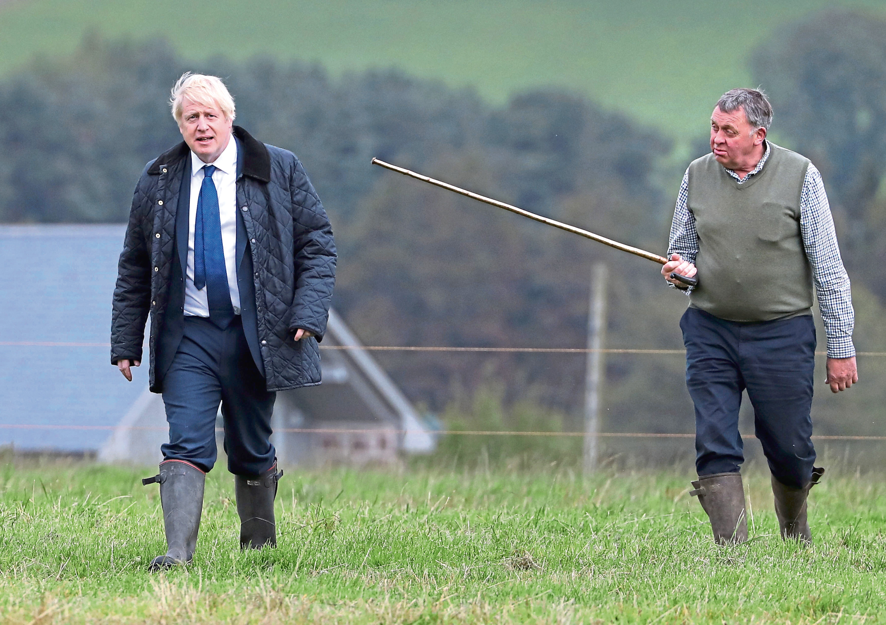 Pete Watson, right, shows Prime Minister Boris Johnson around his Darnford Farm.