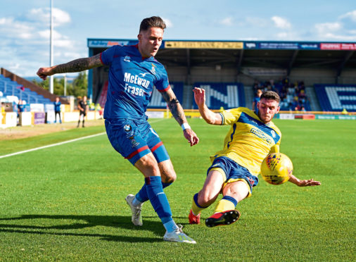 Miles Storey of Inverness and Adam Livingstone during the Tunnocks Caramel Wafer Challenge Cup 3rd Round between Inverness and Morton