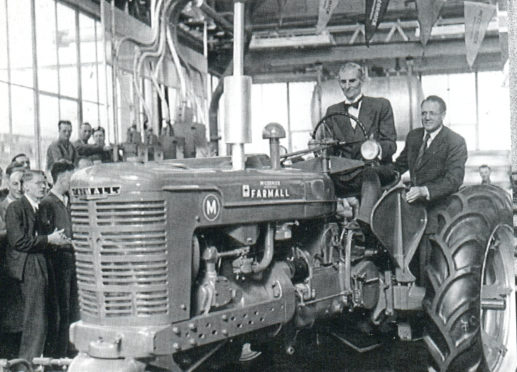 Minister of Agriculture Tom Williams with IH GB Managing Director J A Purves looking on drive the first British built Farmall M off the Doncaster line on September 13, 1949.