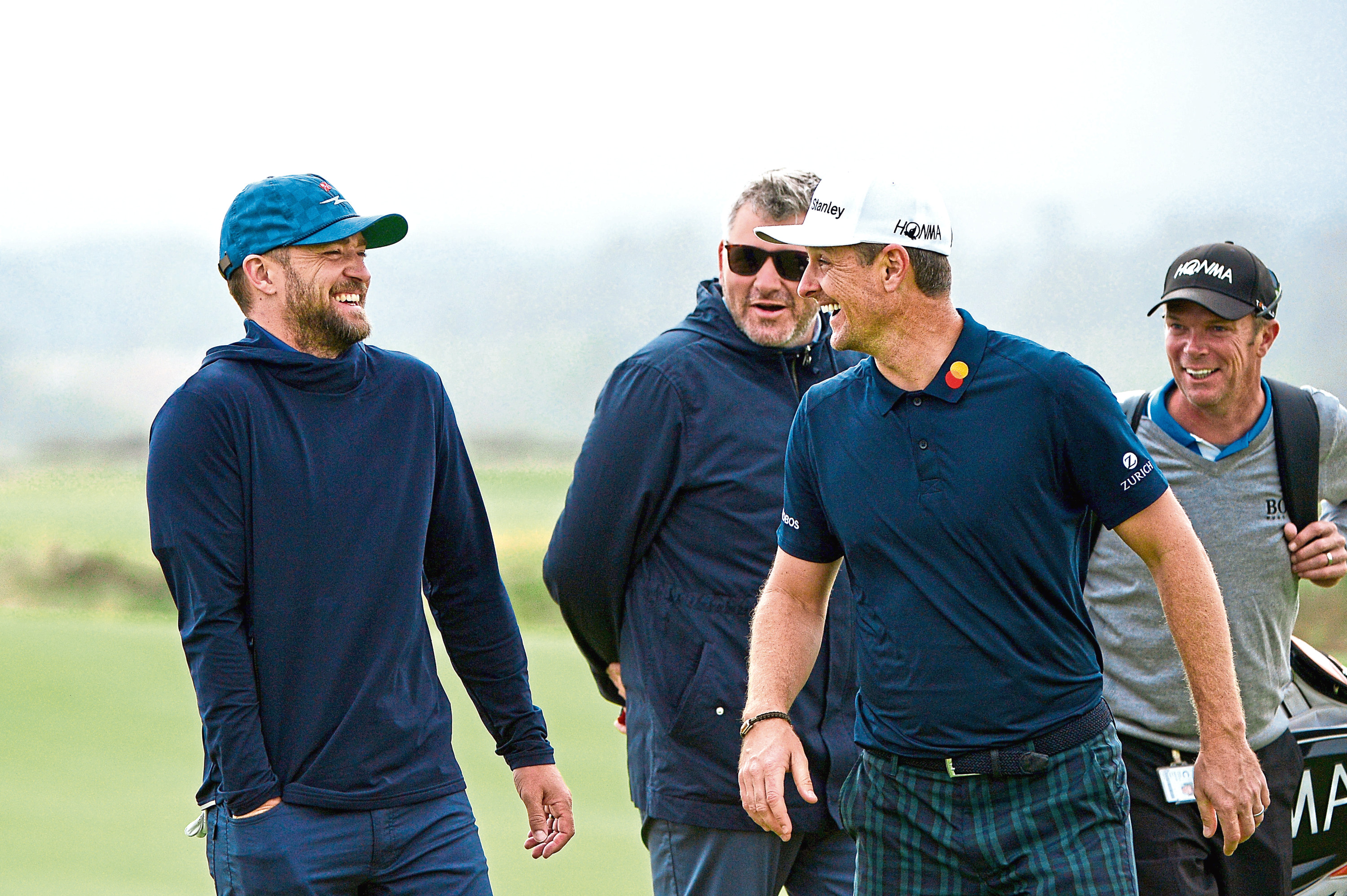 Justin Rose stands with musician, Justin Timberlake as they share a joke on the fifth green during previews for the Alfred Dunhill Links Championship at The Old Course. (Photo by Mark Runnacles/Getty Images)
