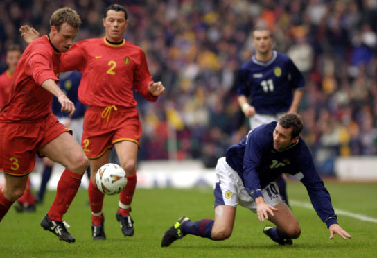 Belgium's Joos Valgaeren (left) takes the ball from Scotland's Don Hutchison during the World Cup Group Six qualifier game at Hampden Park, Glasgow on March 24, 2001. Photo: Ben Curtis