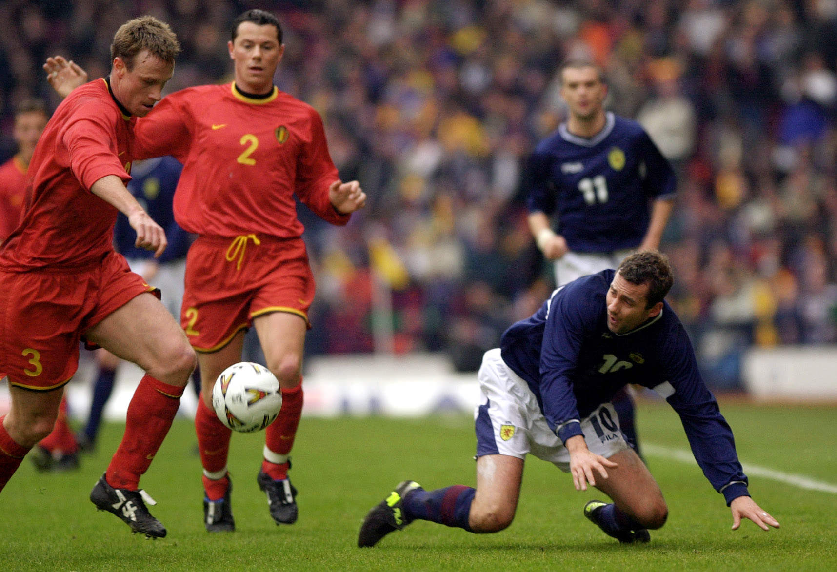 Belgium's Joos Valgaeren (left) takes the ball from Scotland's Don Hutchison during the World Cup Group Six qualifier game at Hampden Park, Glasgow on March 24, 2001. Photo: Ben Curtis