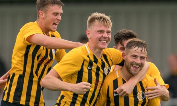 Gordy McNab, front right, celebrates with his Nairn County team-mates.