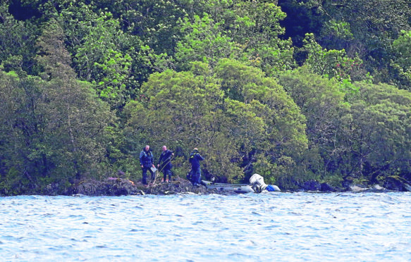 Police Scotland dive team searching the small islands where the boat capsized.
Picture by Kevin McGlynn