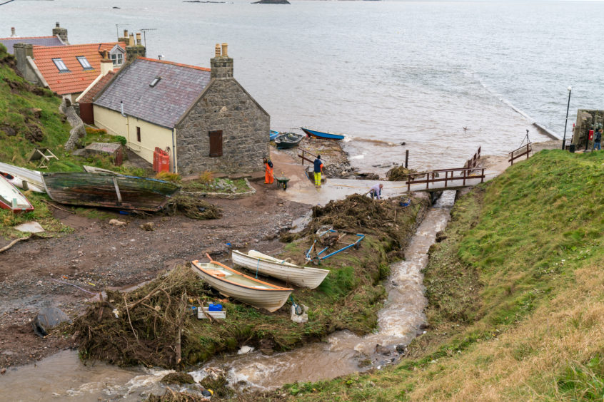 Locals clearing the damage in Crovie