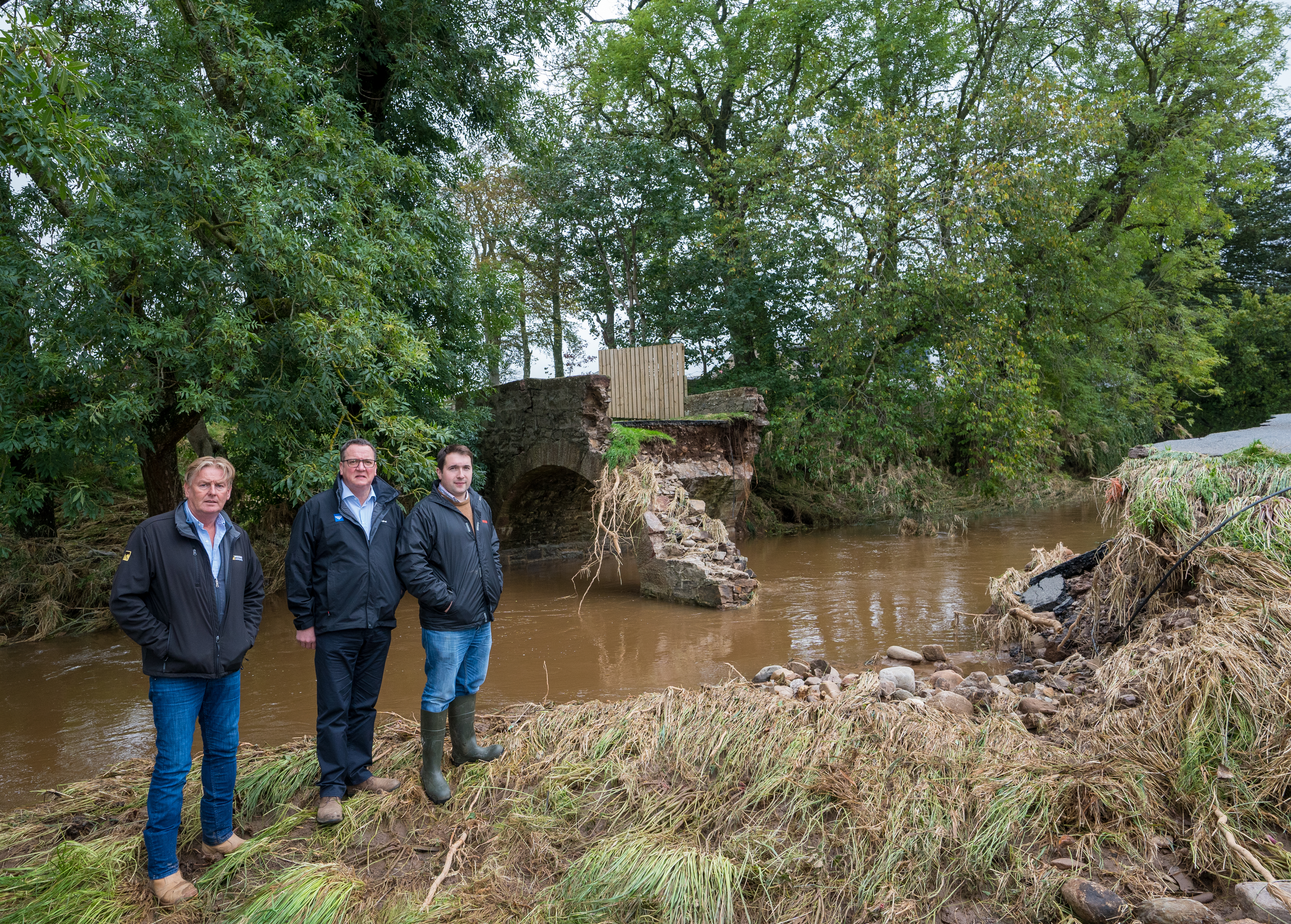 L-R: Farmers, Wilson Strachan, Philip Benzie and Charles Duguid at one of the bridges that collapsed.