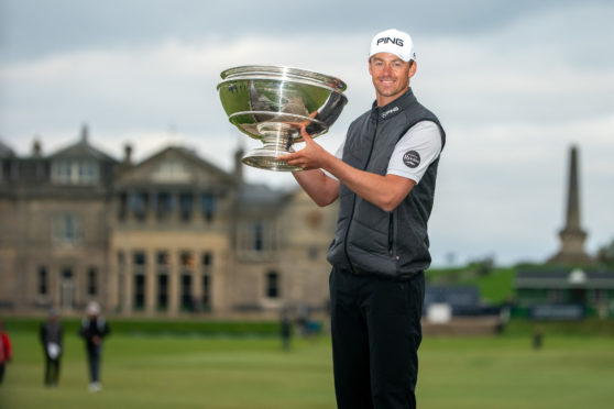 Victor Perez proudly shows off the trophy following his win during day four of the Alfred Dunhill Links Championship at St Andrews. PA Photo.