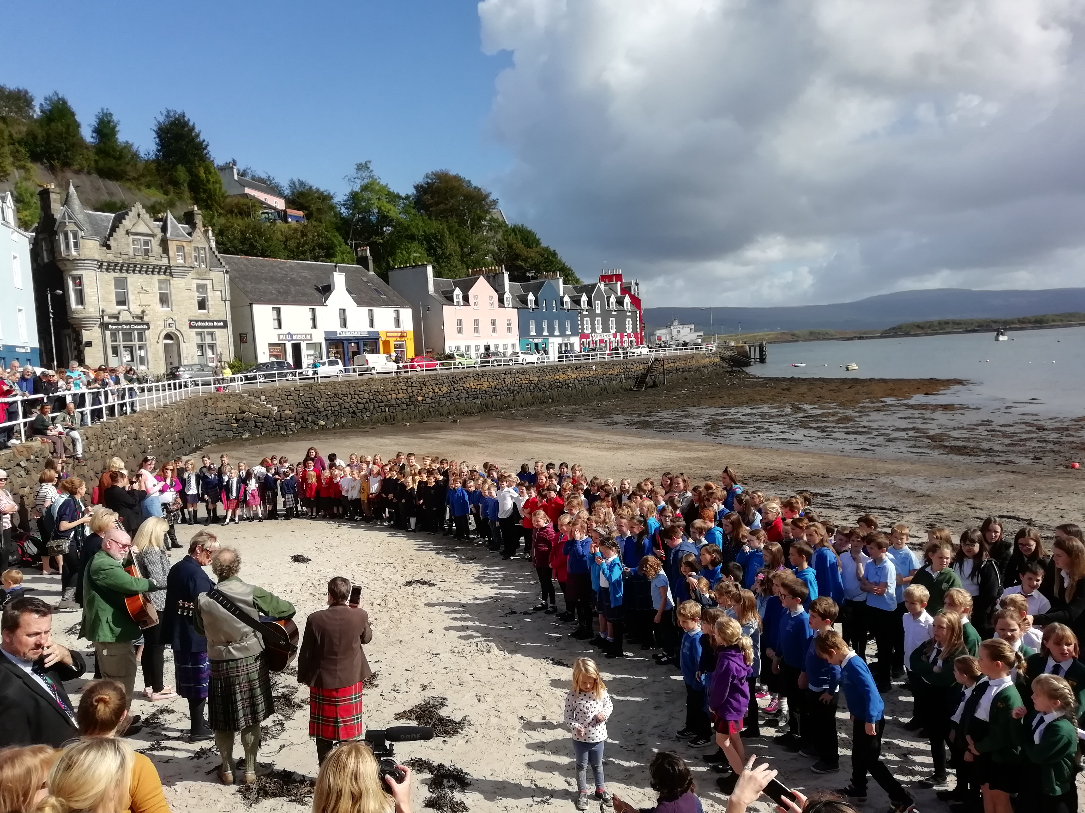 Hundreds of children sing on the beach at Tobermory