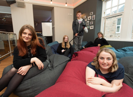 Elgin Youth Cafe is inviting members past and present to attend a 21st birthday party of the group to celebrate it coming of age. Pictured: Marketing officer Emma Smith-Hunter, volunteer Teigan MacLennan, volunteer Aidan Henderson , volunteer Elysia Glass, volunteer Lauren Robertson. Picture by Jason Hedges