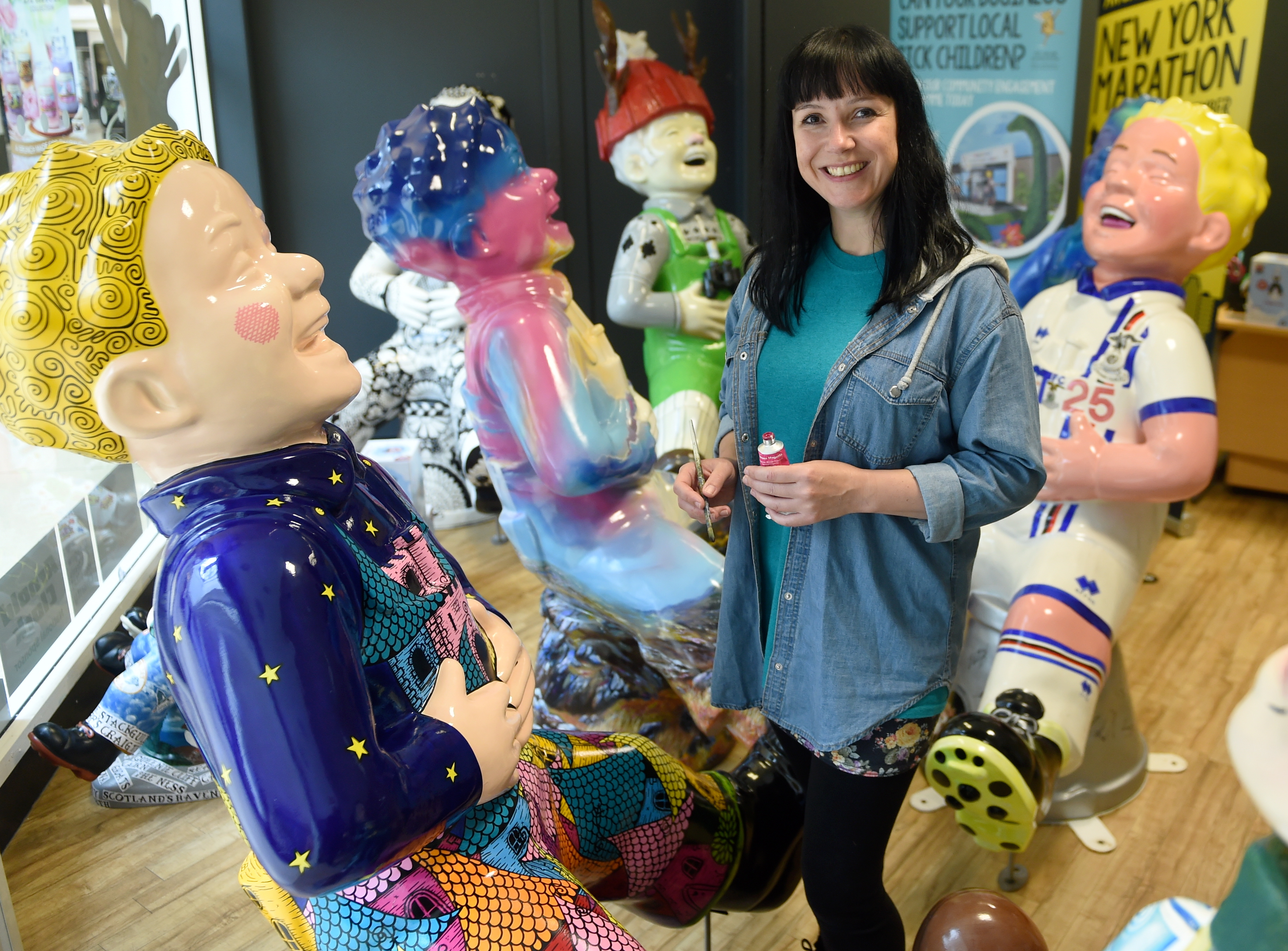 Art Director of the Oor Willie's Big Bucket Trail, Suzanne Scott in Inverness yesterday titivating the ten Inverness statues before their farewell event and auction later this month. Picture by Sandy McCook