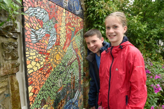 A new mosaic built with the help of pupils of Crown Primary School, Inverness was unveiled at the Highland Hospice. Here are Liam Buchan and Lucy McIntosh admiring their work. Picture by Sandy McCook