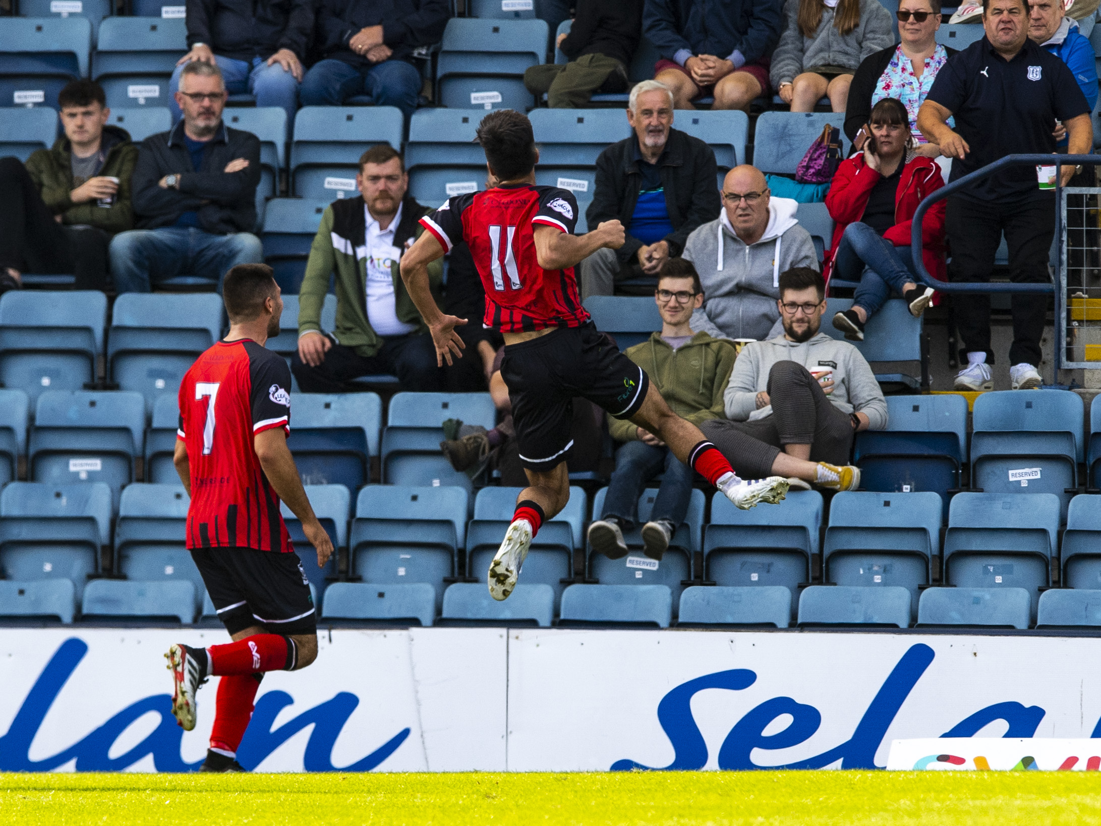 Rabin Omar celebrates in front of the Dundee fans.