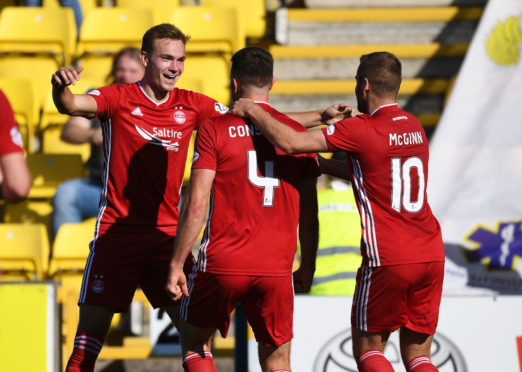Aberdeen's Andrew Considine (centre) celebrates his goal at Livingston