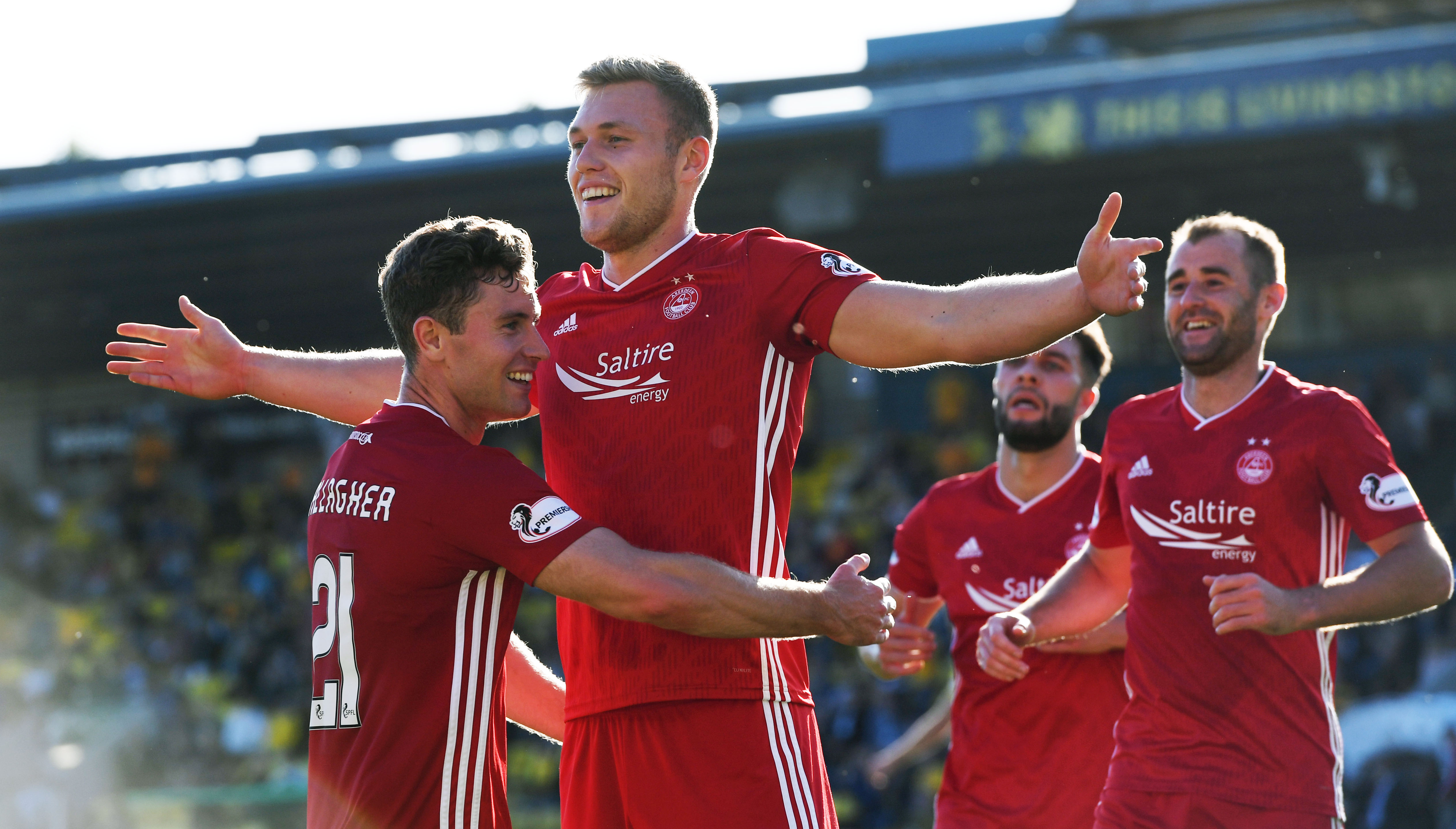 Aberdeen's Sam Cosgrove (centre) celebrates his goal  against Livingston.