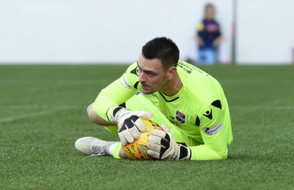 Ross County's Ross Laidlaw clutches the ball after saving Osman Sow's penalty.