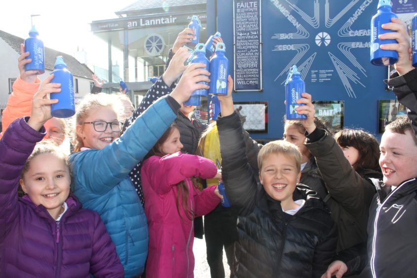 P6 and P7 pupils from Back Primary School say cheers to Scottish Water’s new Top Up Tap outside the An Lanntair Arts Centre in Stornoway